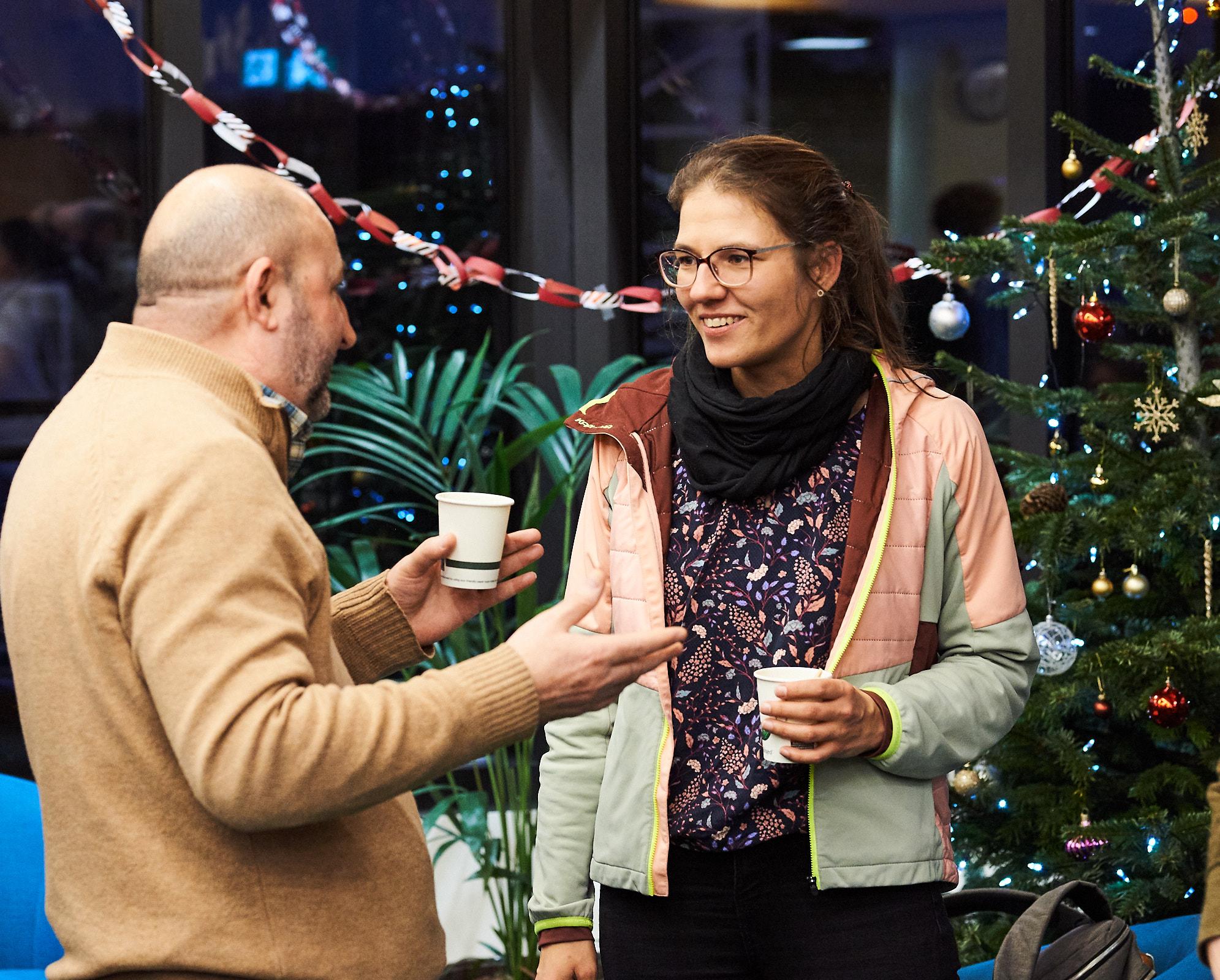 A photo of Alec Pogosyan and Catharina Zich talking at winter Science Day 2022