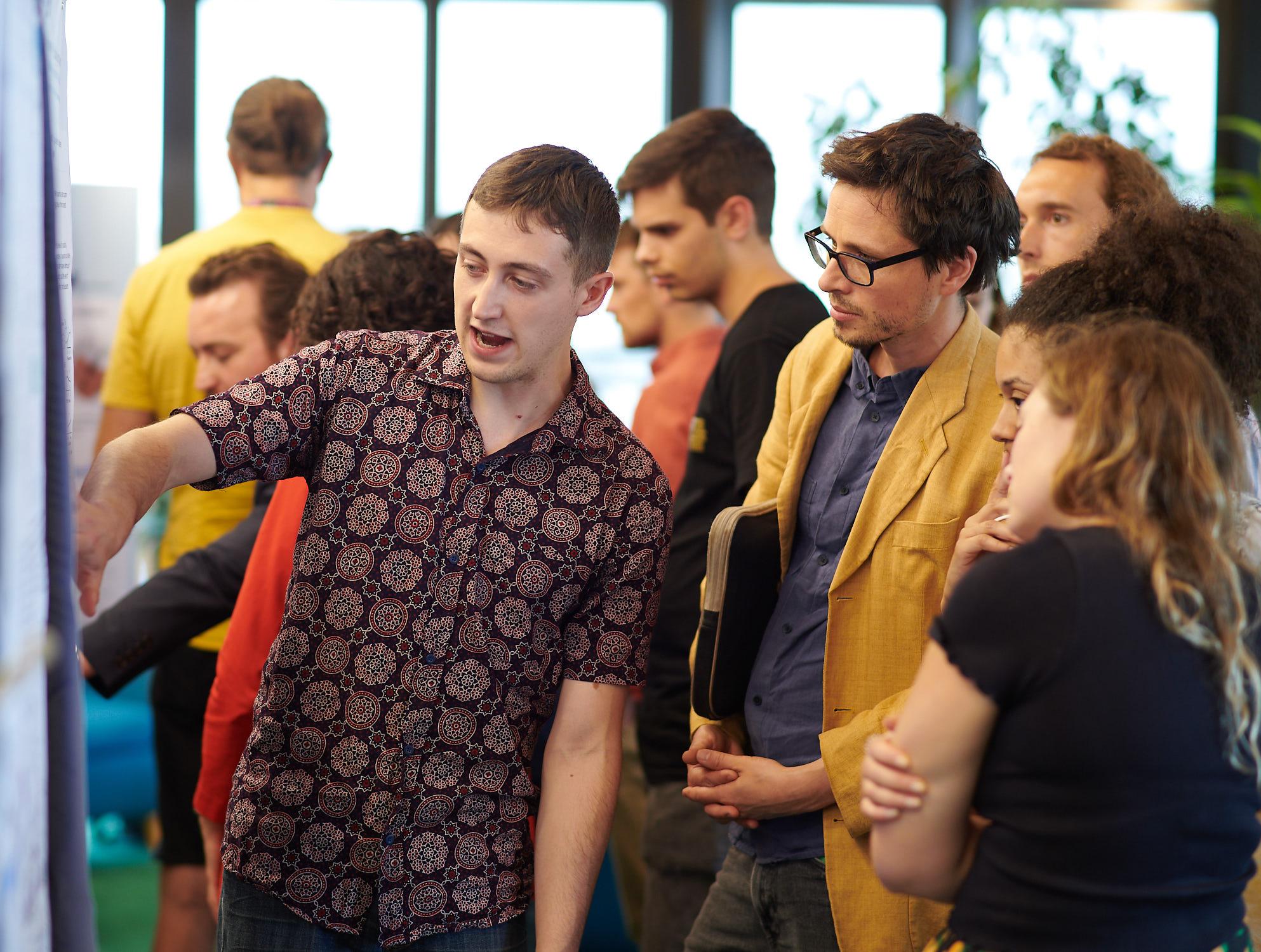 A photo of Isaac Grennan and Unit colleagues talking at summer Science Day 2023.