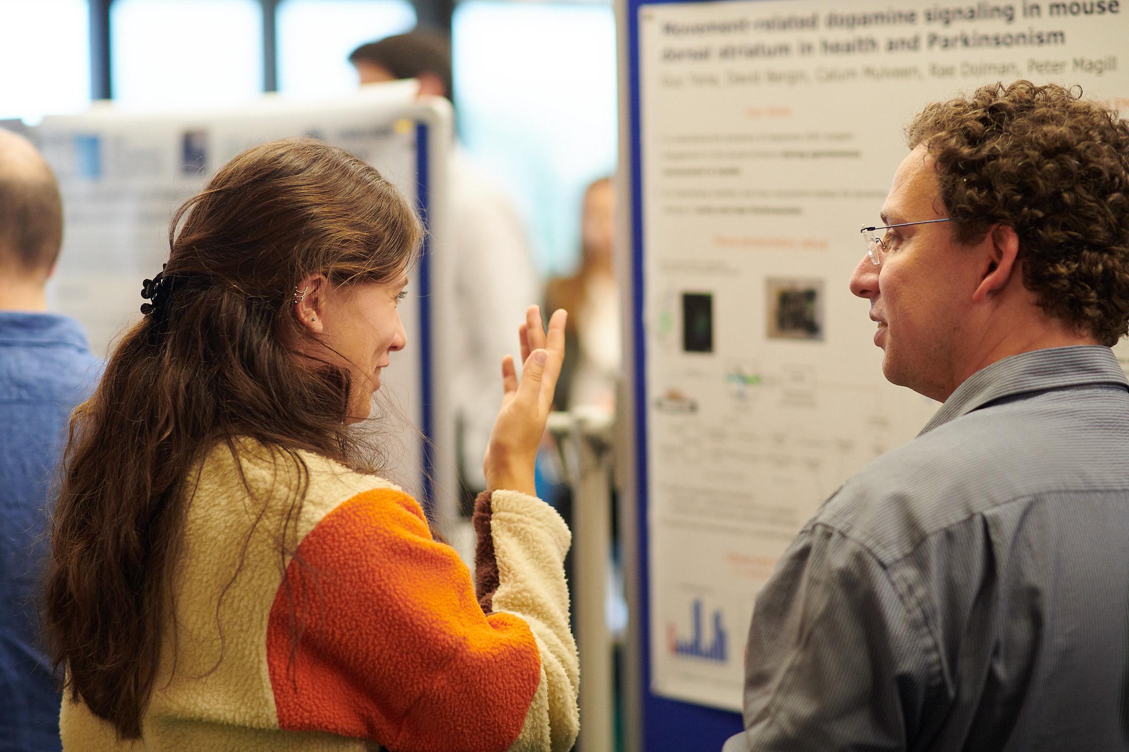 A photo of Unit members talking at summer Science Day 2023.