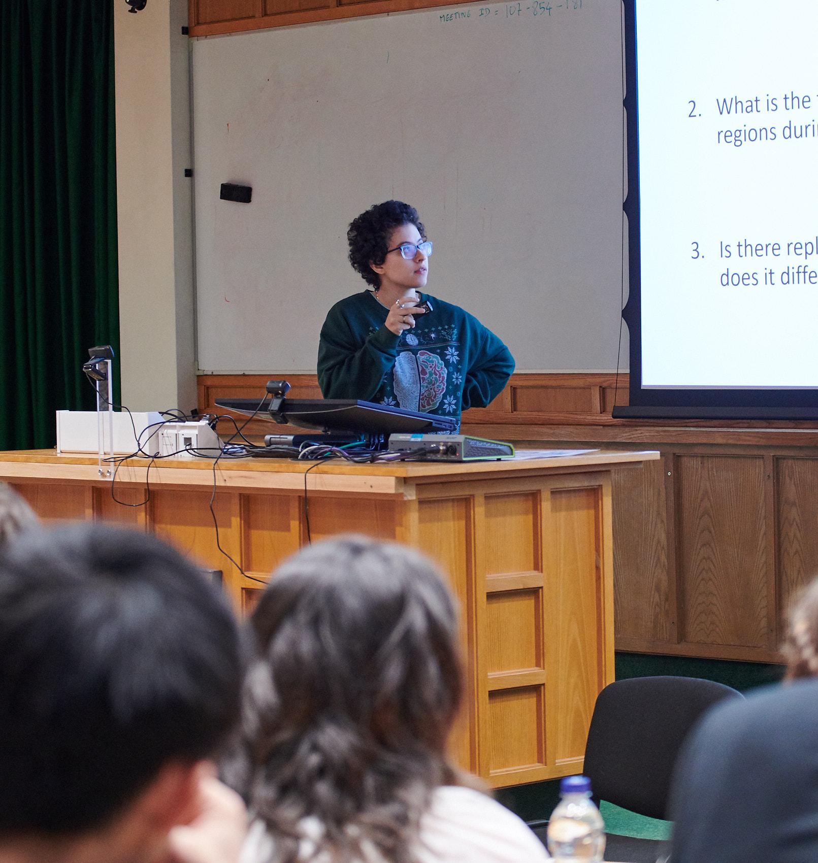 A photo of Cal Shearer presenting research to Unit colleagues.