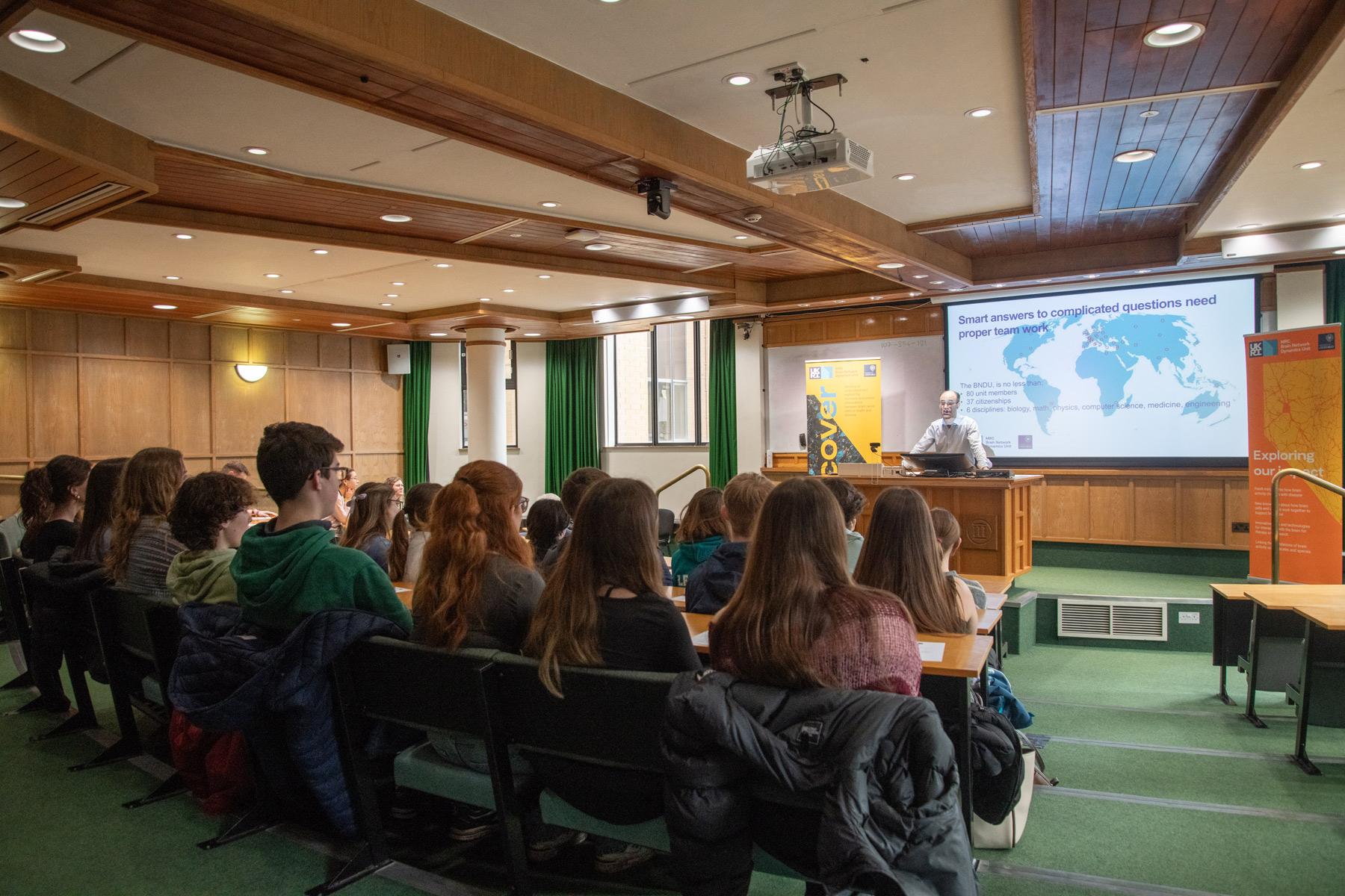 Photo of David Dupret speaking with school pupils visiting the Unit.