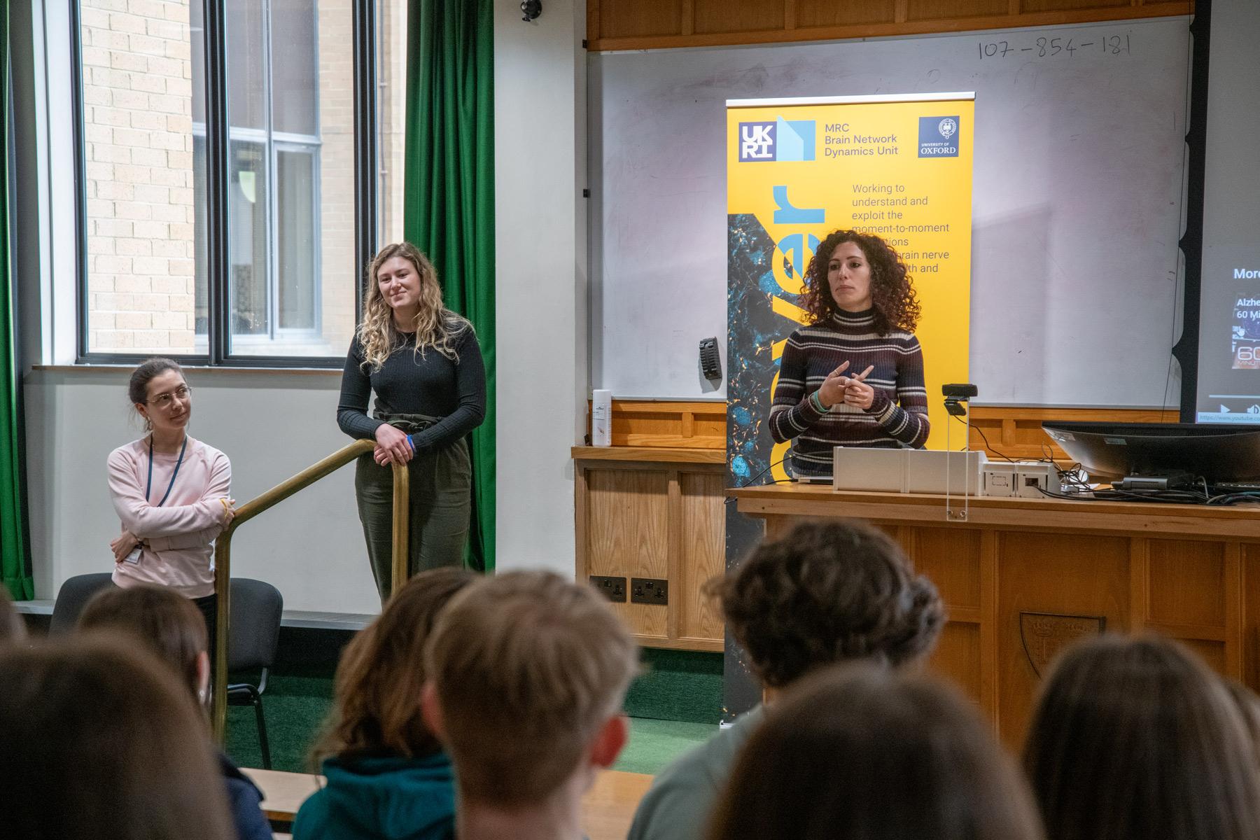 Photo of Melissa Serrano speaking with school pupils visiting the Unit.