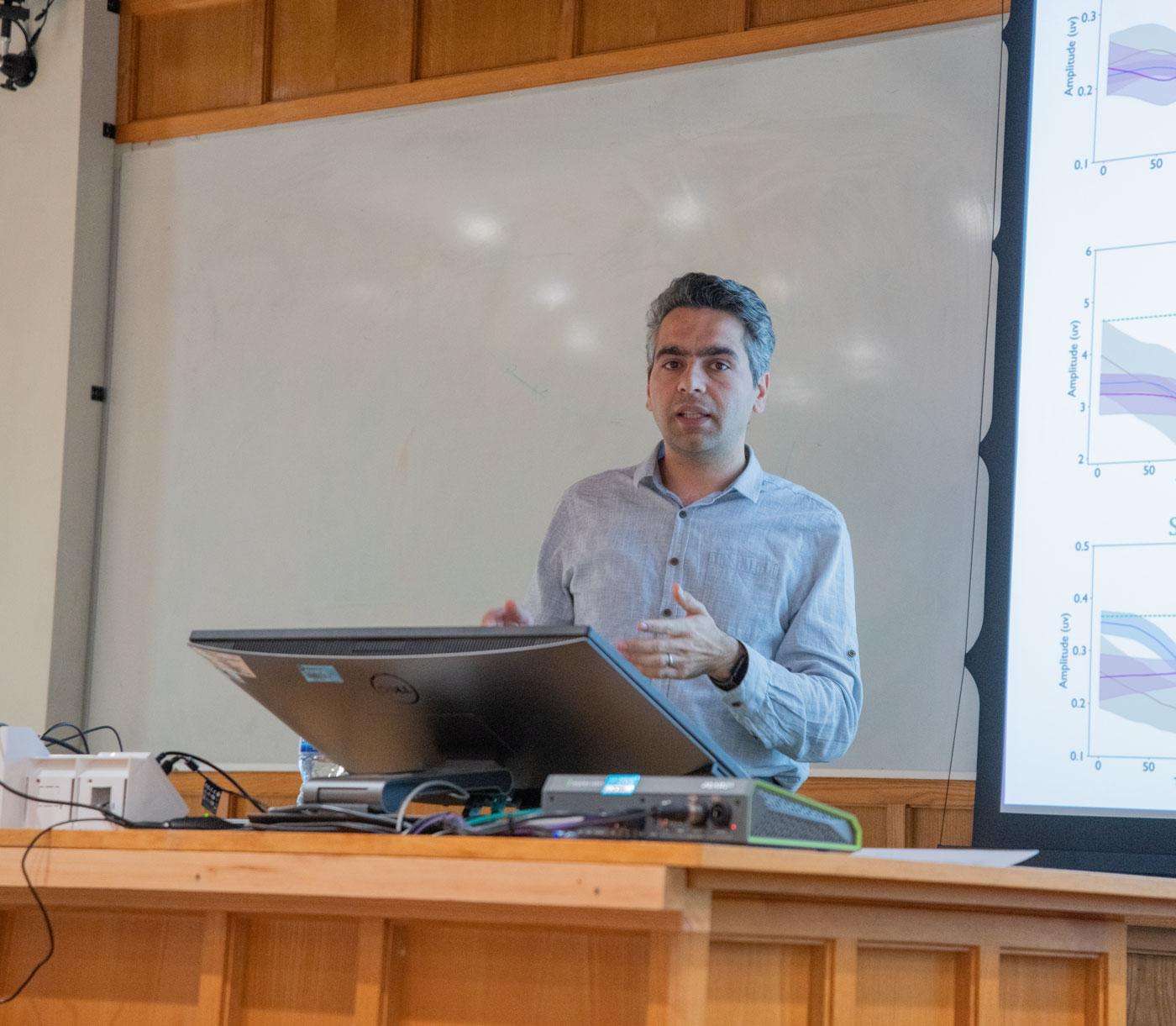 A photo of Bahman Abdi-Sargezeh presenting his research to Unit colleagues.