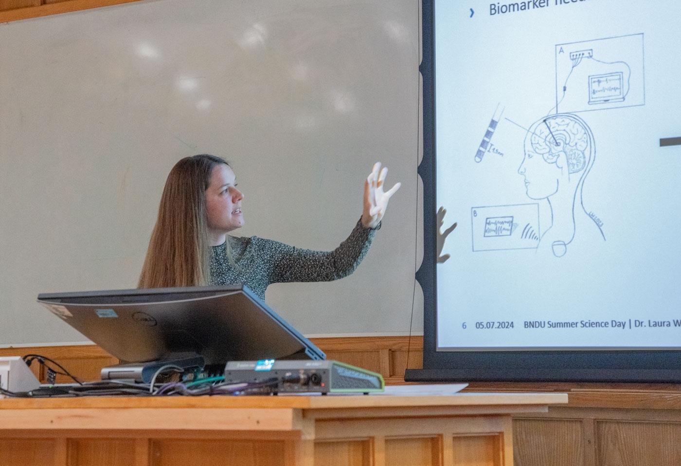 A photo of Laura Wehmeyer presenting her research to Unit colleagues.