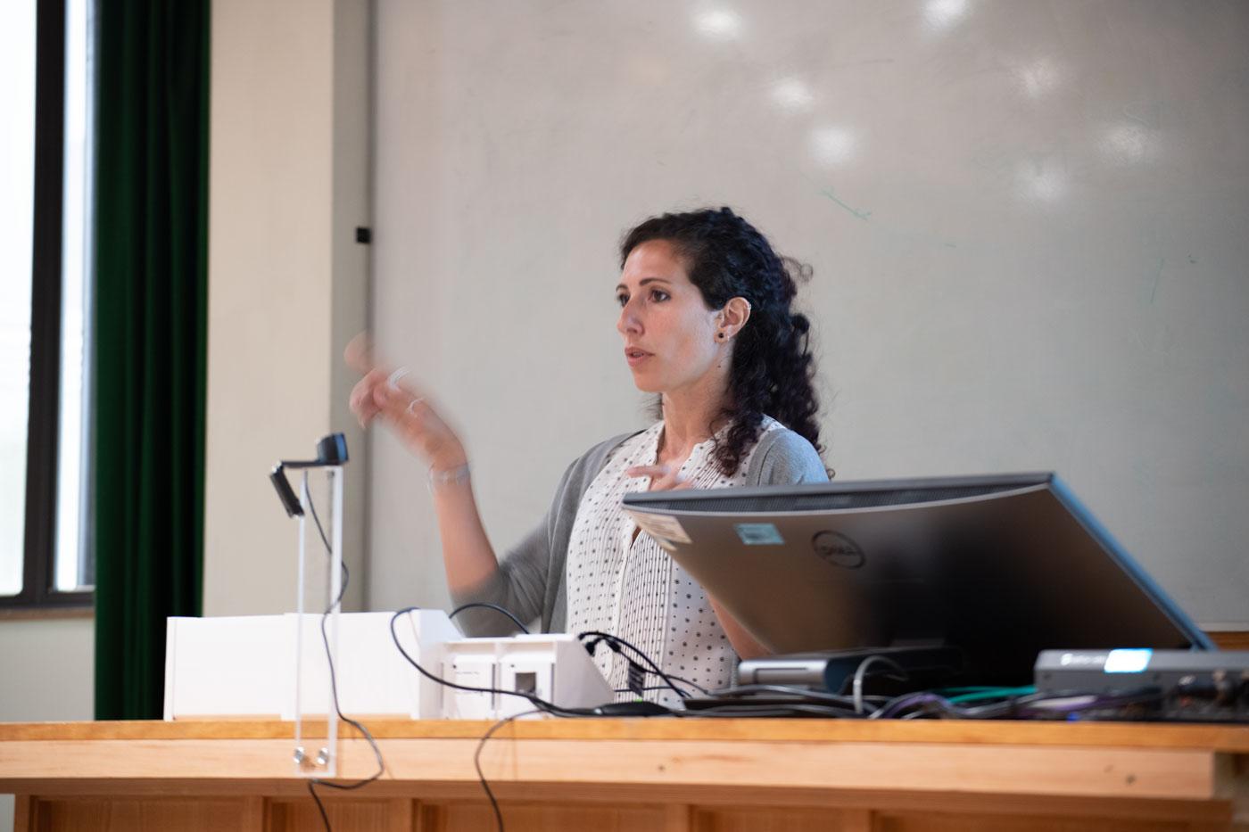 A photo of Melissa Serrano presenting her research to Unit colleagues.