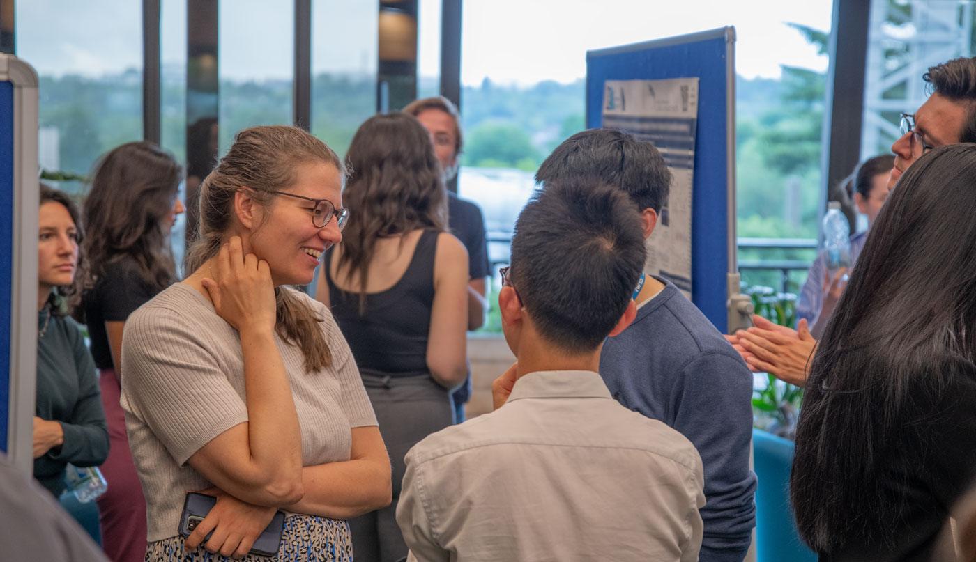 A photo of Unit researchers talking at Summer Science Day 2024.