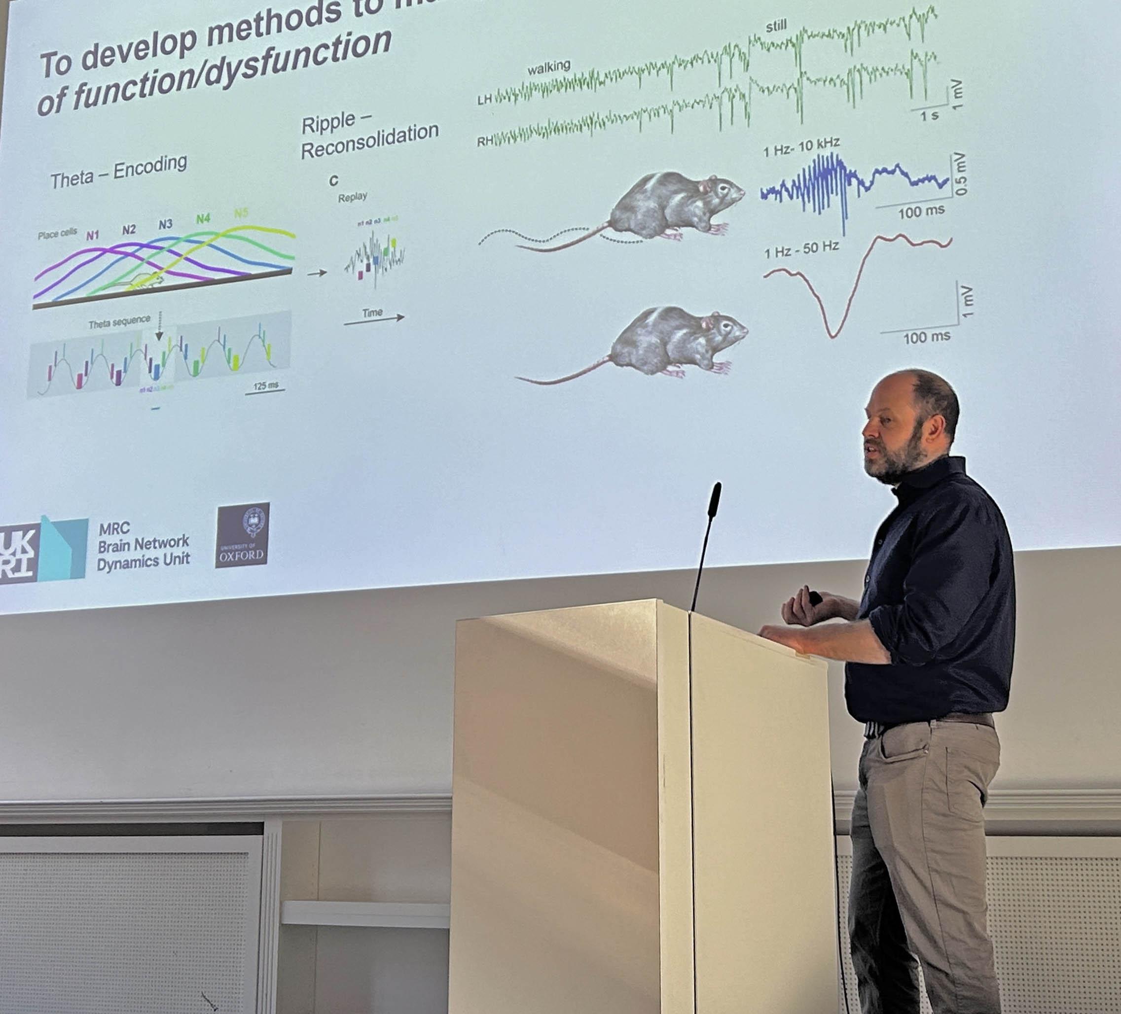 Prof. Andrew Sharott presenting.